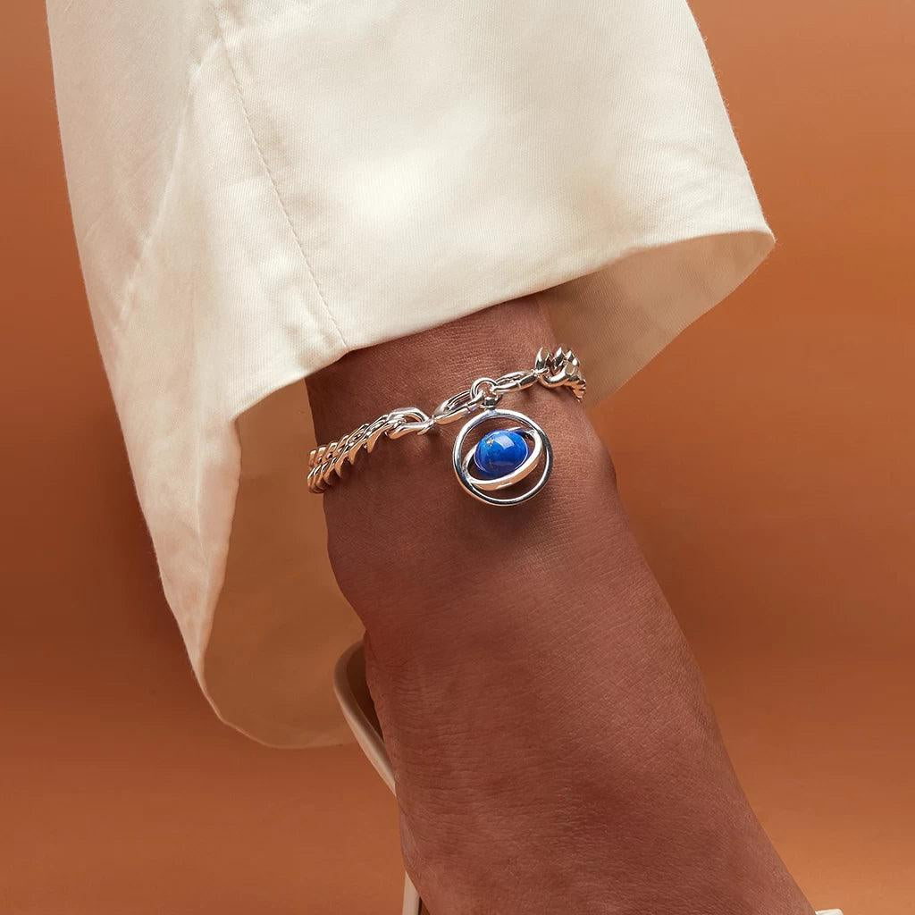Cosmos-themed silver anklet featuring a blue planetary charm and chunky links