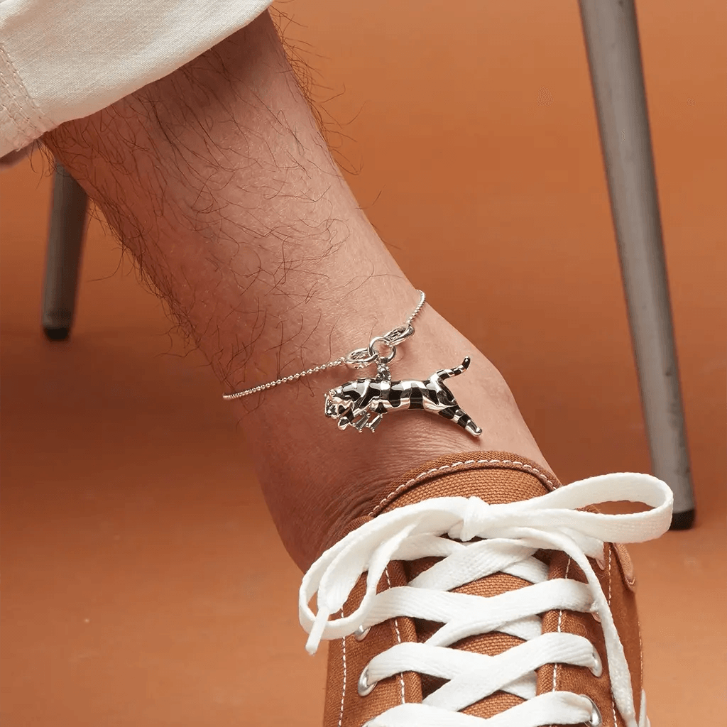 Sterling silver anklet with detailed cheetah charm on man's ankle