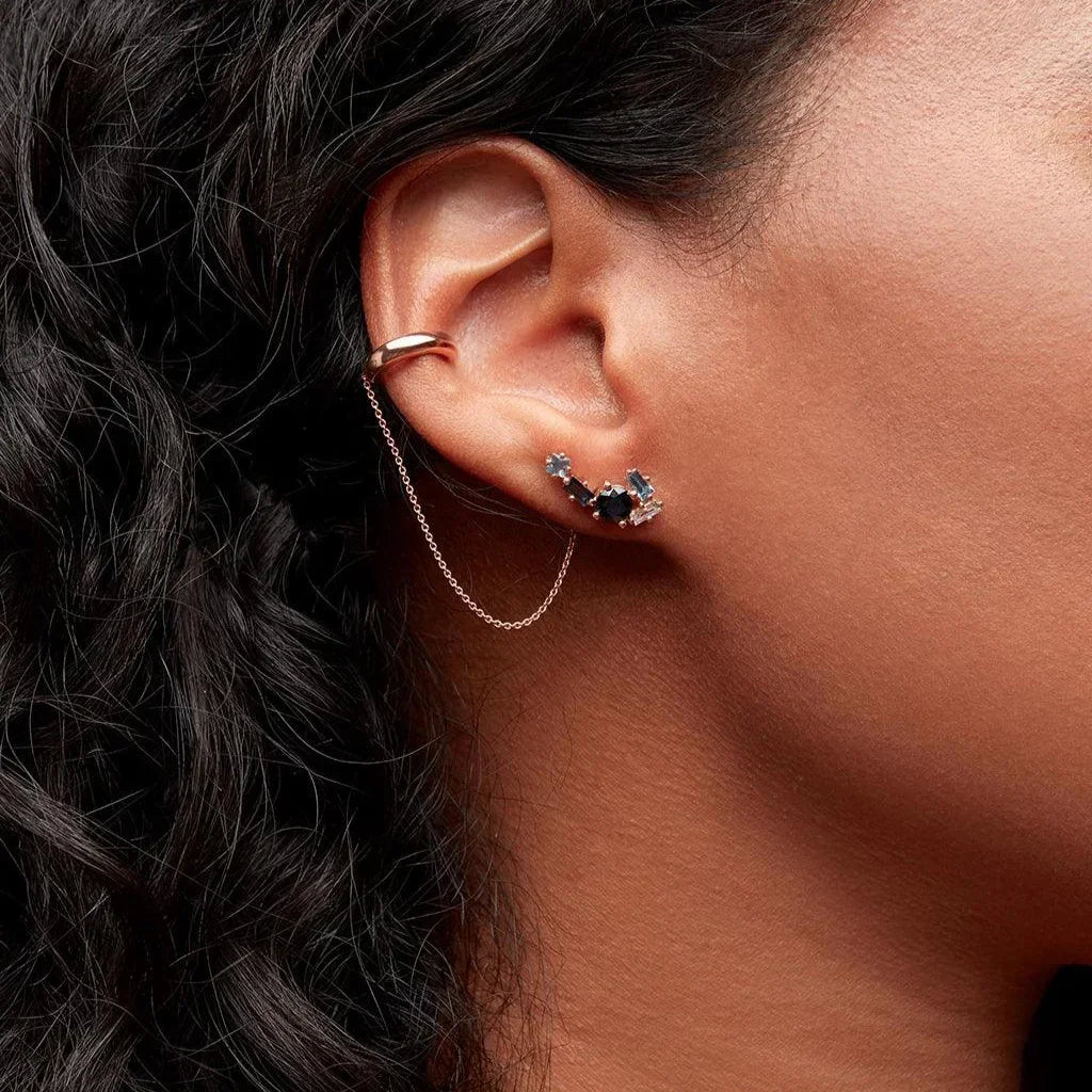 Rose gold ear cuff with elegant chain detail and statement gemstone cluster studs