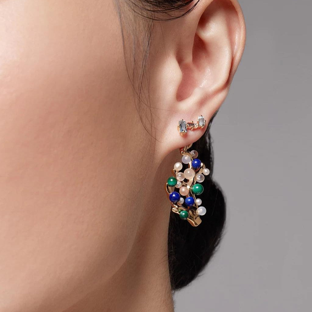 Gold blue topaz ear crawler styled with colorful multi-stone statement charm.