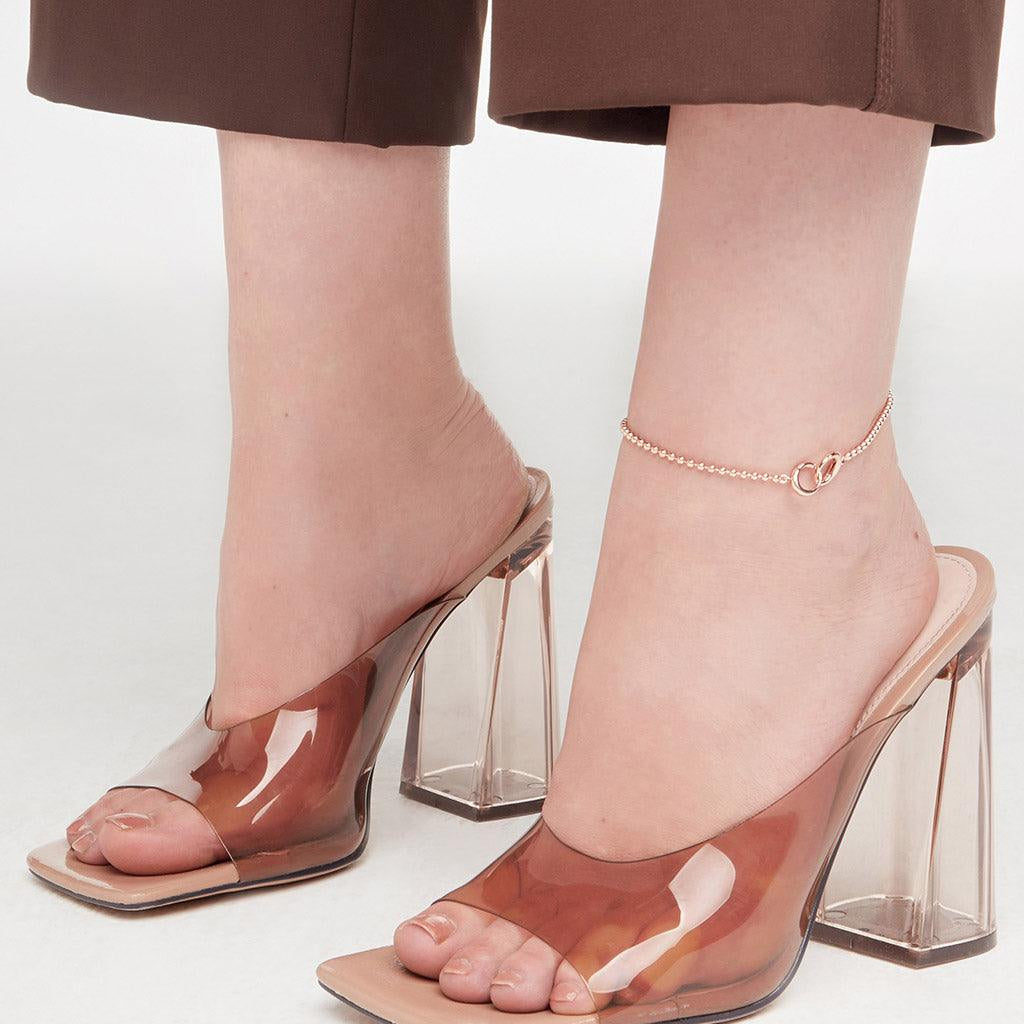 Rose gold beaded anklet styled with transparent block heels