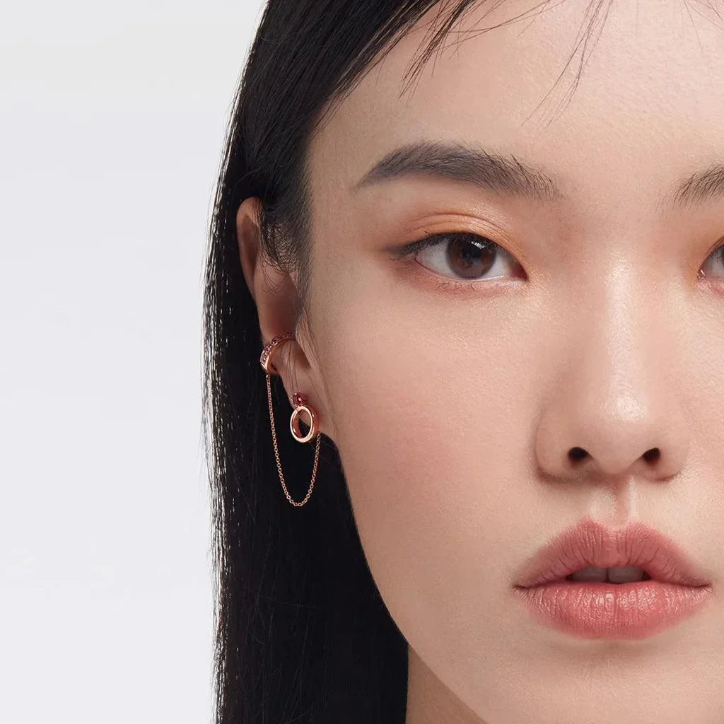 Rose gold chain ear cuff styled with open circle hoop earring for modern layered ear look