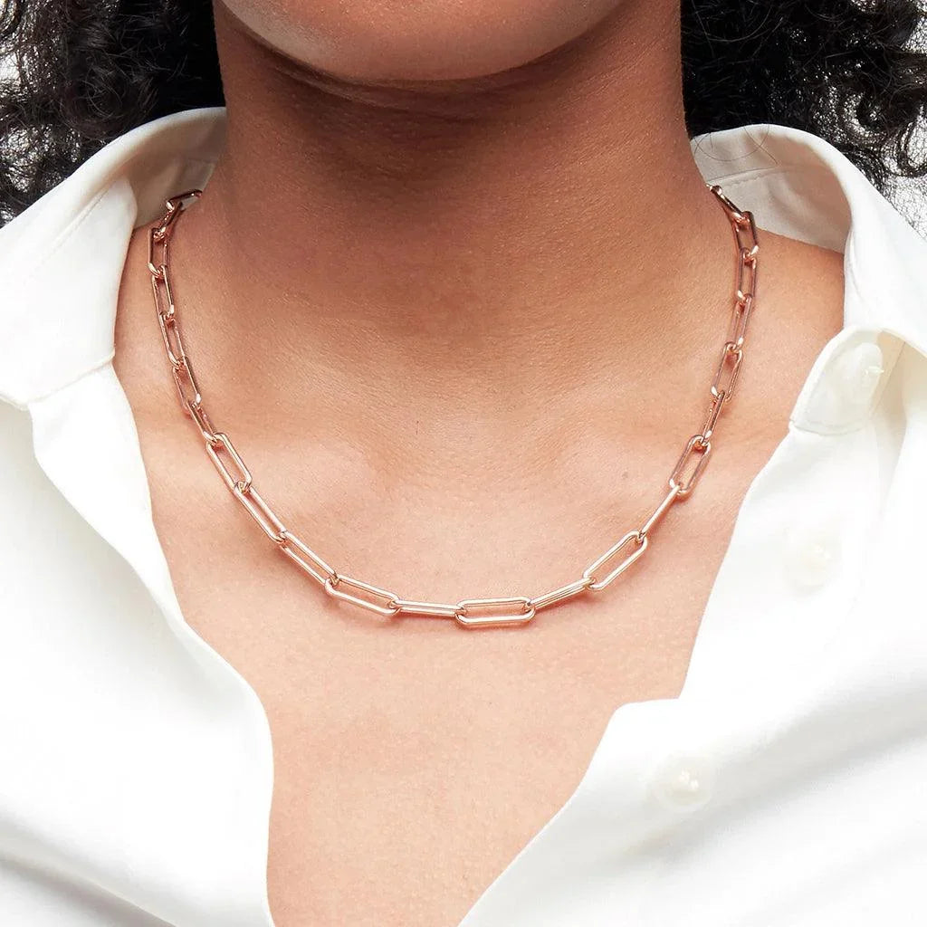 Rose gold paperclip chain necklace styled on a model.