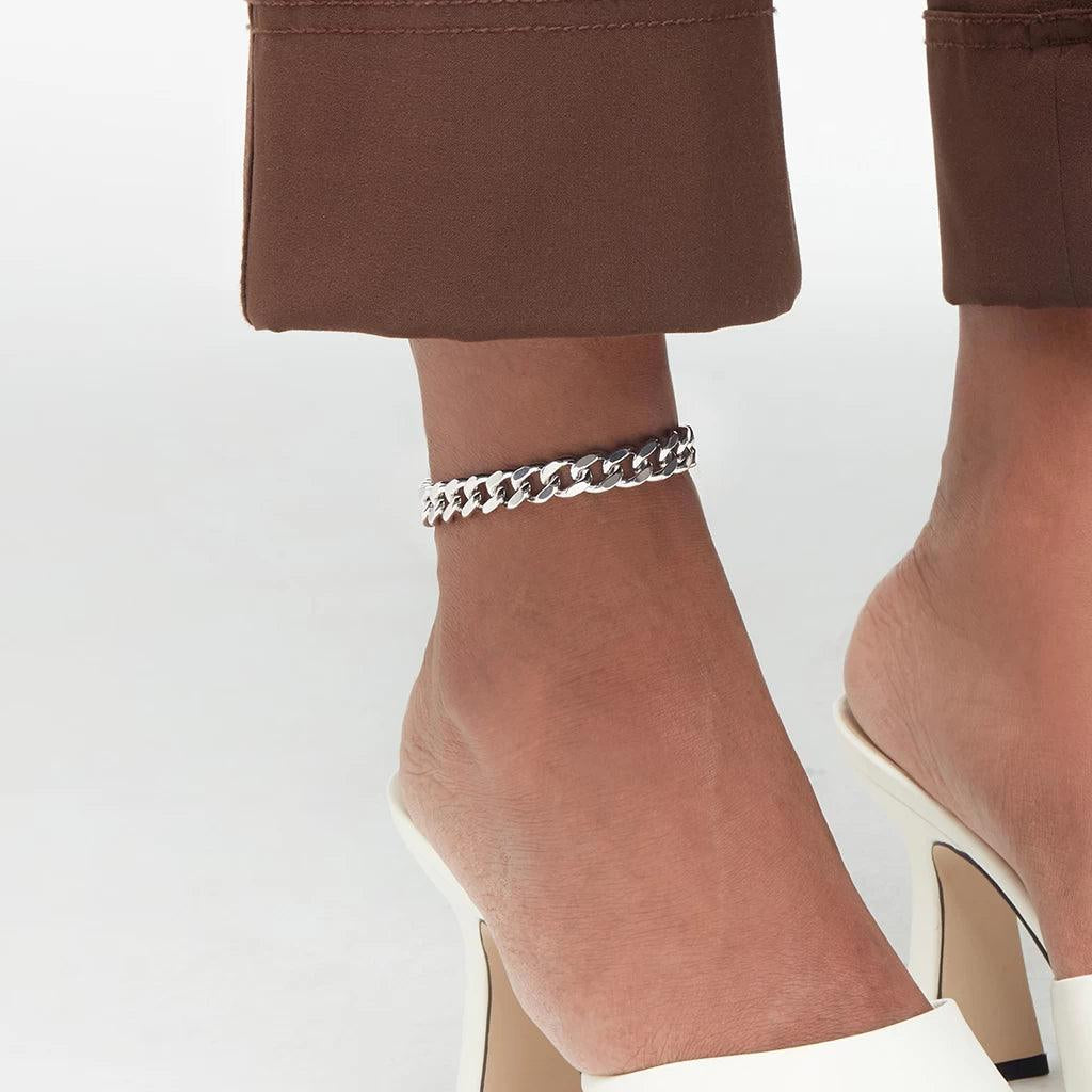 Sterling silver curb chain anklet styled with white heels for a minimal look