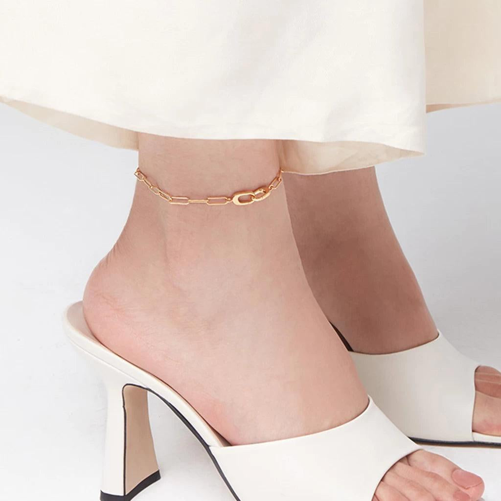 Elegant gold chain anklet styled with white high heels