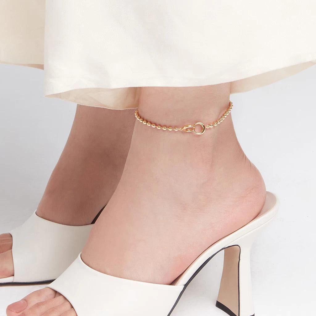 Women's gold bead chain anklet styled with ivory heels