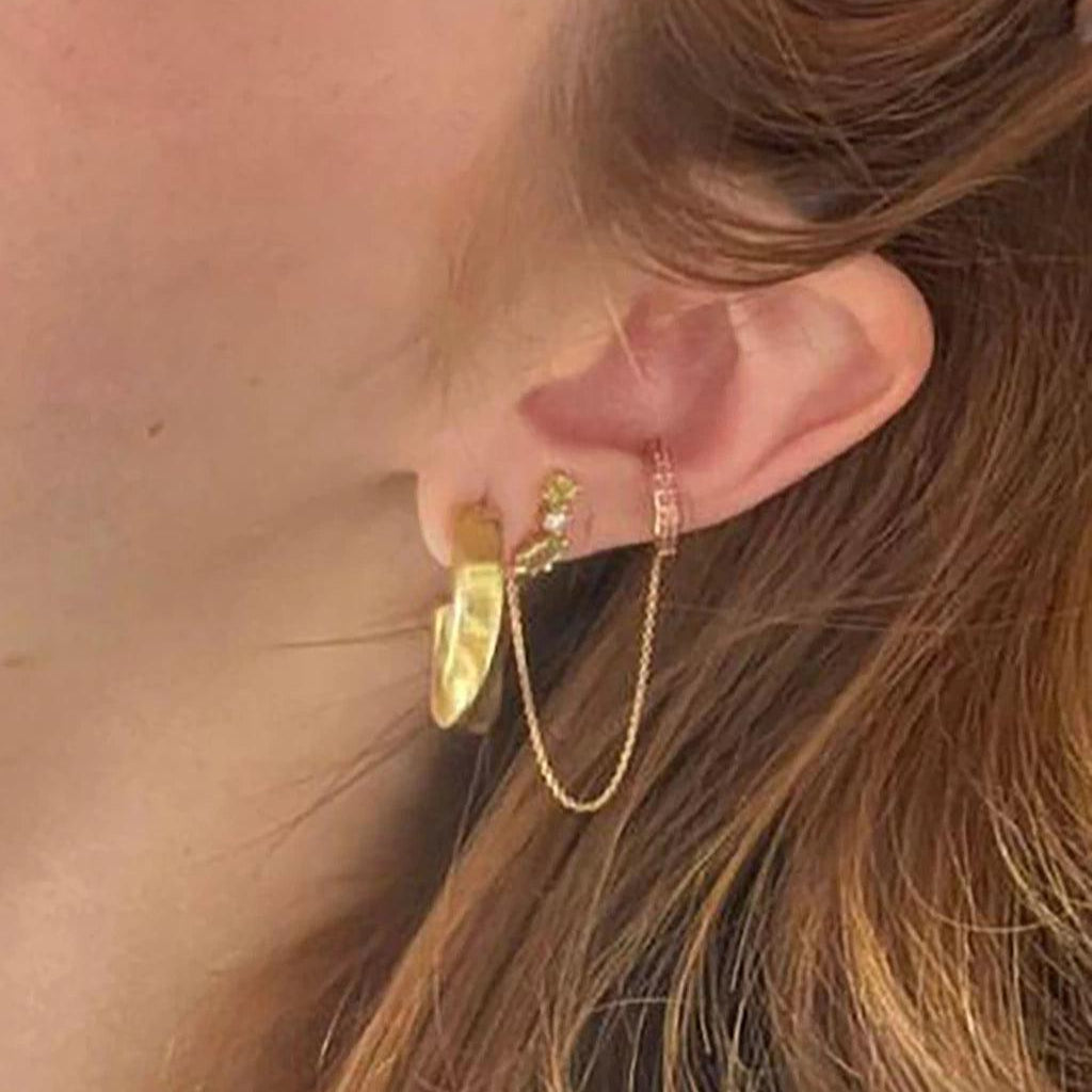 Gold hoop earring layered with rose gold chain ear cuff for elegant, mixed-metal ear styling