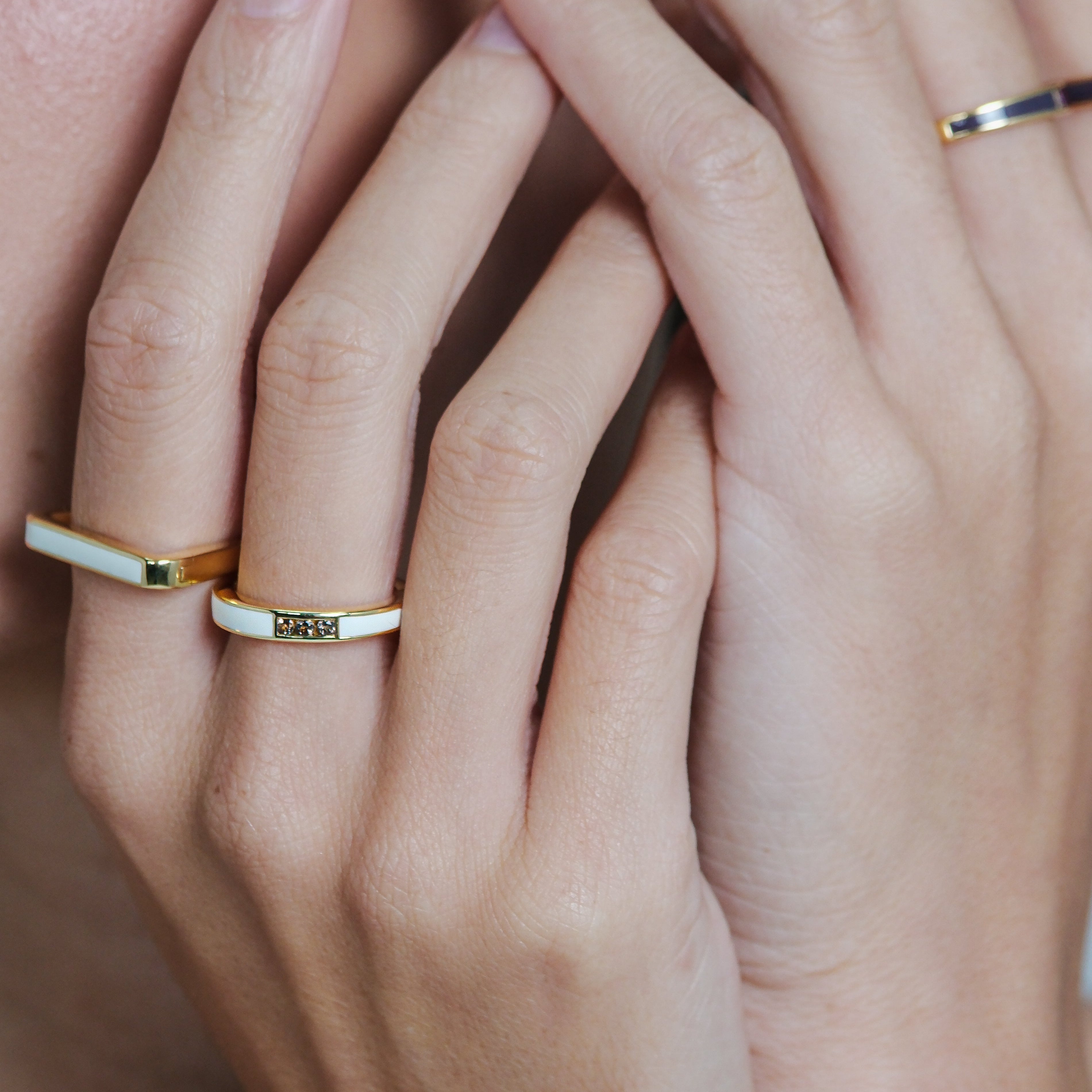 Close-up of hands with gold rings on fingers