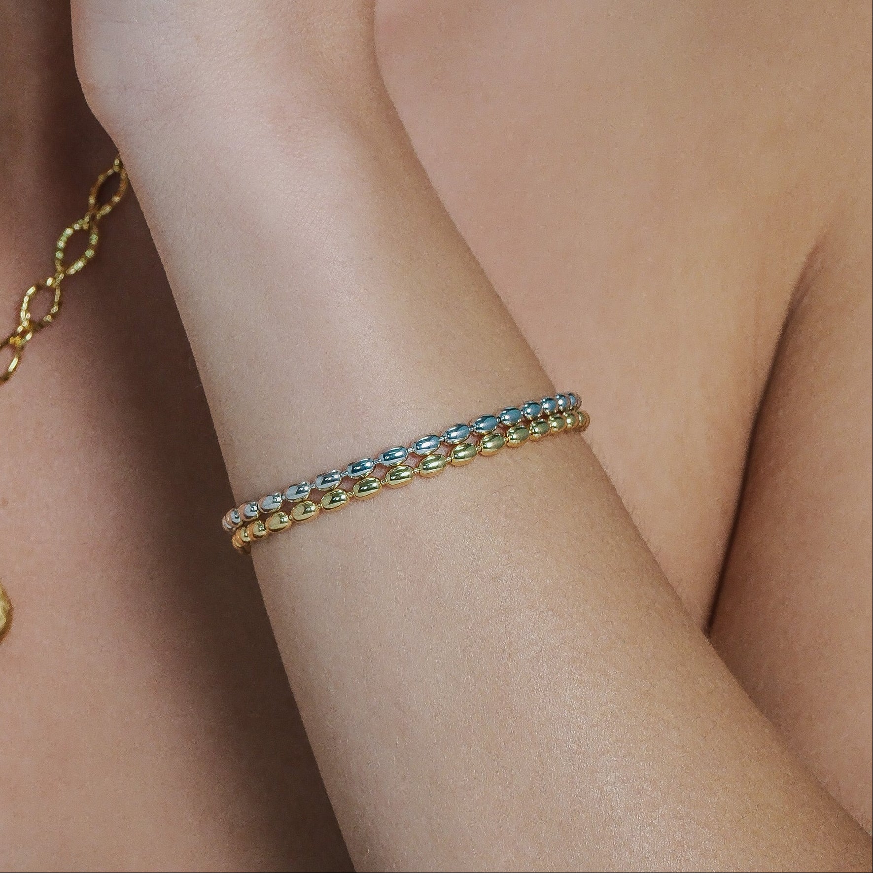 Gold and silver and bracelets worn on wrist