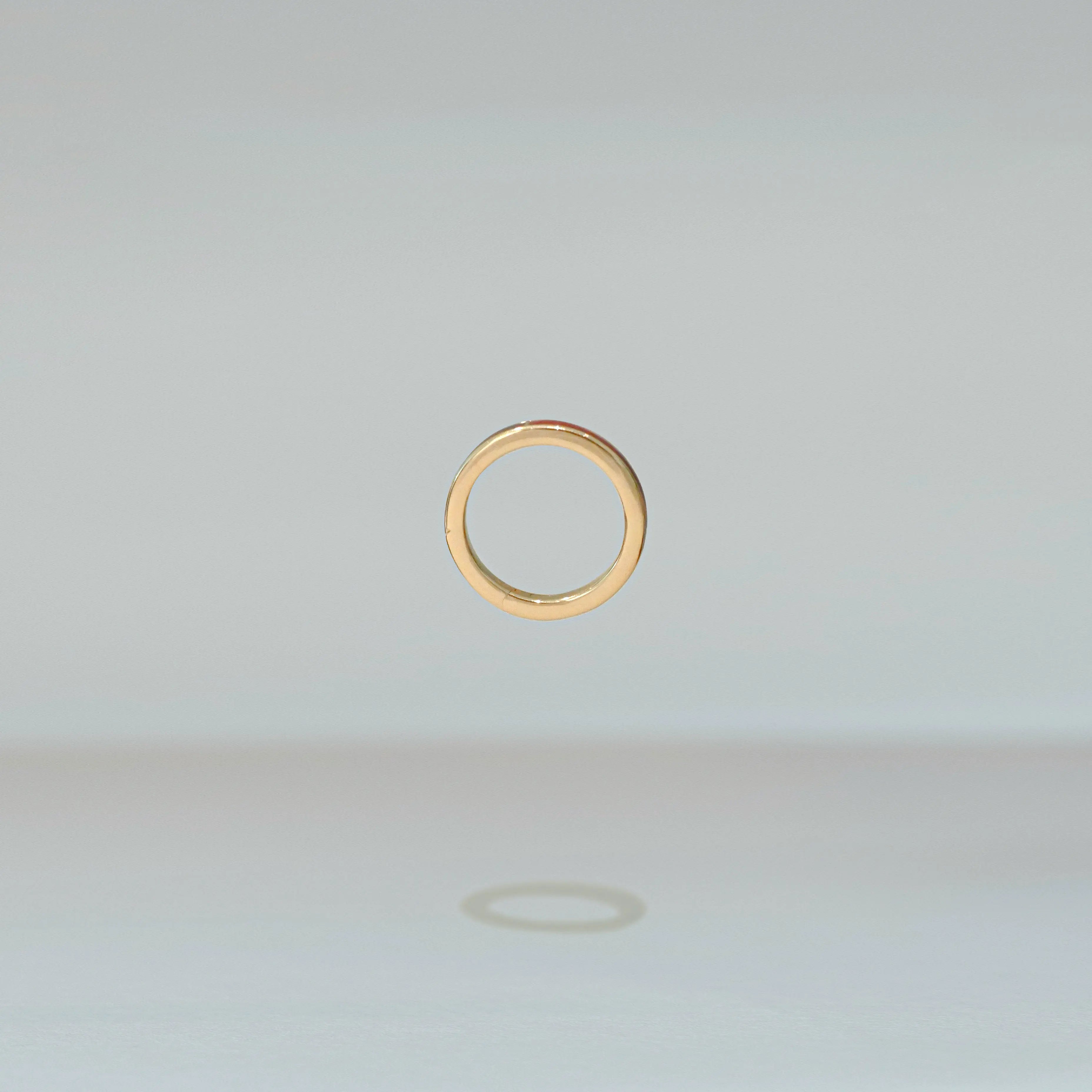 Gold ring on a light gray background