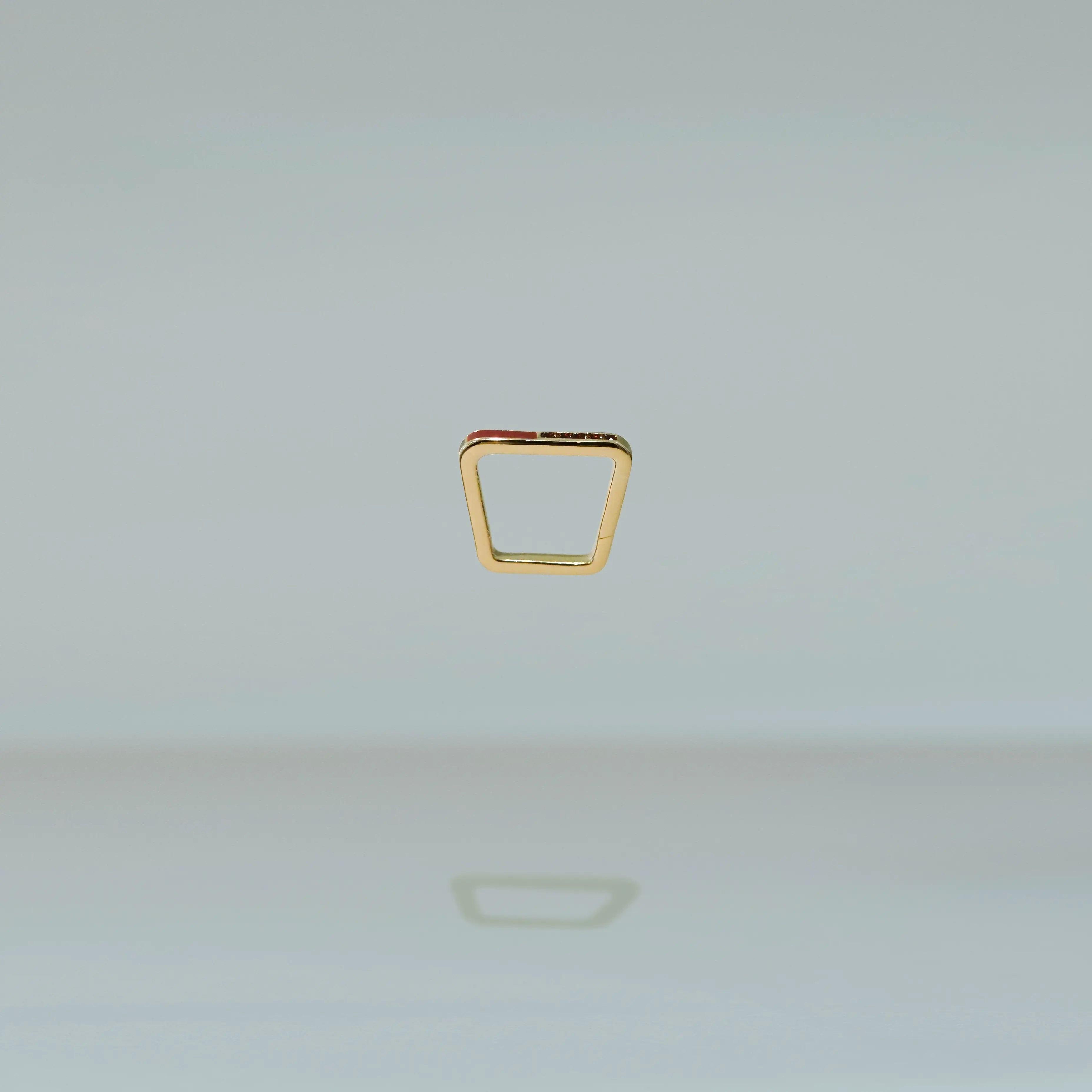 Gold ring on a light gray background