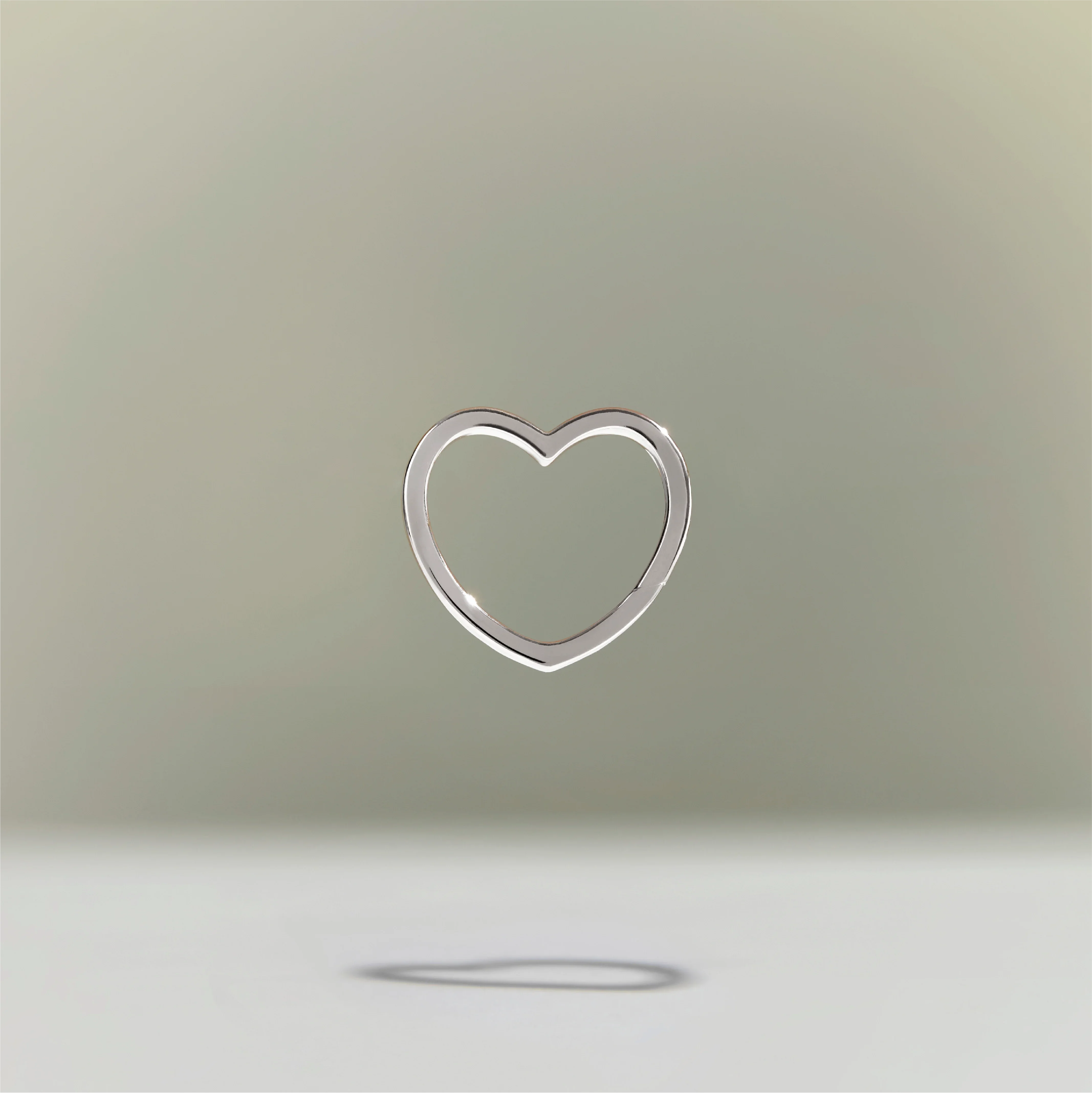A heart-shaped silver lock with 14K gold plating on a neutral background.