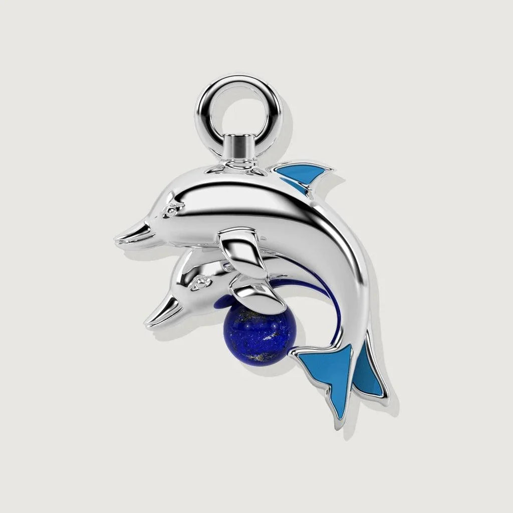 Silver dolphin charm with lapis lazuli bead and blue enamel fins on a plain background.