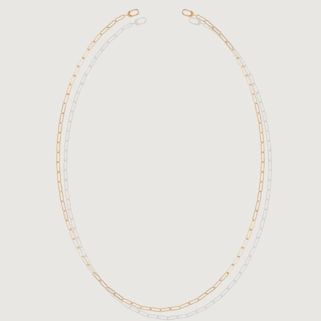 Minimalist rose gold paperclip chain necklace displayed on white background.