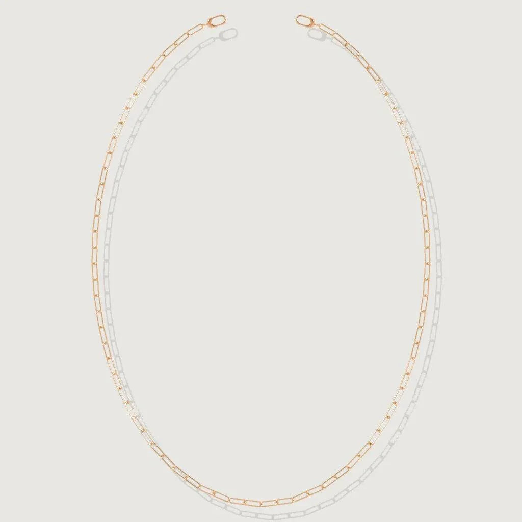 Minimalist rose gold paperclip chain necklace displayed on white background.