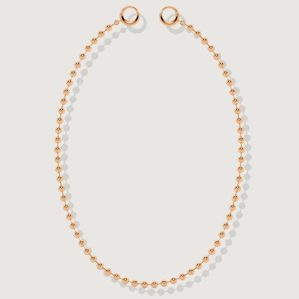 High-polish rose gold beaded choker necklace displayed on plain backdrop.