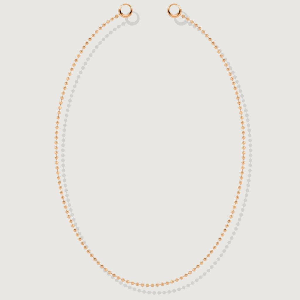 Flat lay of a classic rose gold beaded chain necklace on white background