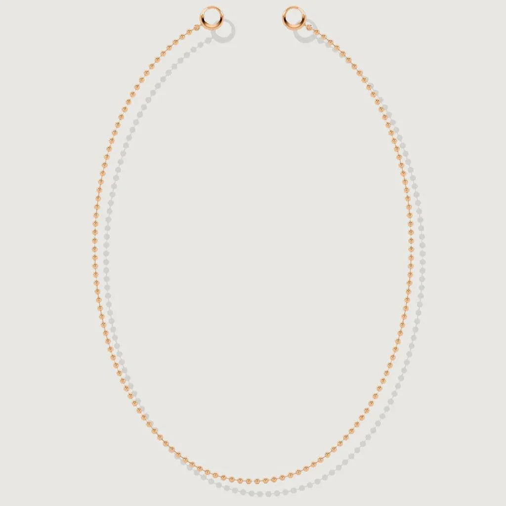 Flat lay of a classic rose gold beaded chain necklace on white background