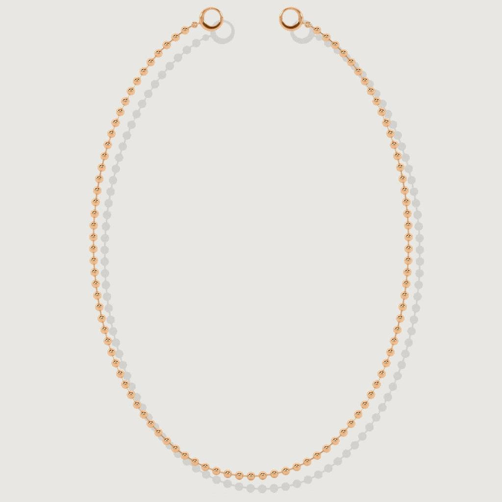 Isolated rose gold beaded necklace with circular clasps on white background.