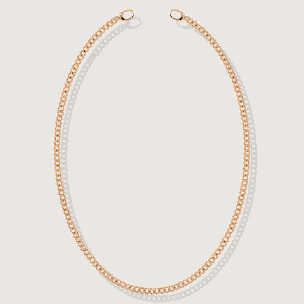 Flat lay of rose gold curb chain necklace with open ring clasp design.