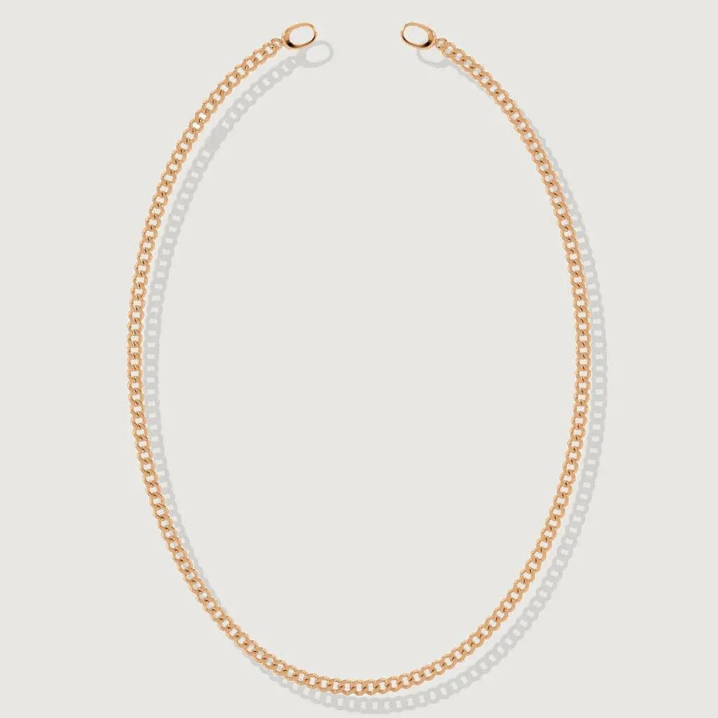 Flat lay of rose gold curb chain necklace with open ring clasp design.
