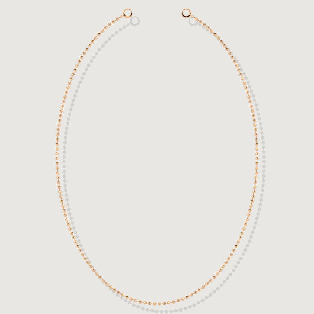 Minimalist rose gold ball chain necklace laid flat on a white background
