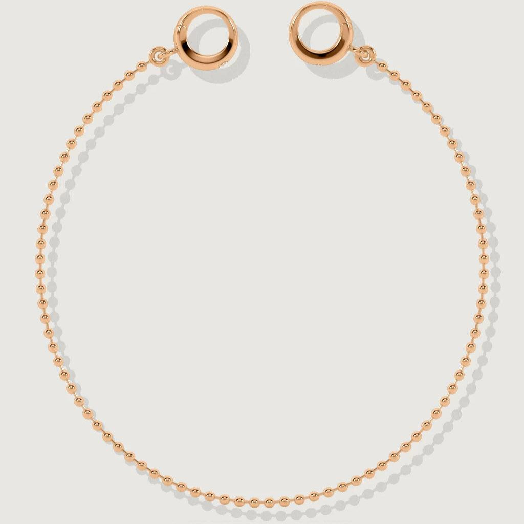 Delicate rose gold ball chain bracelet with open circular ends on white background
