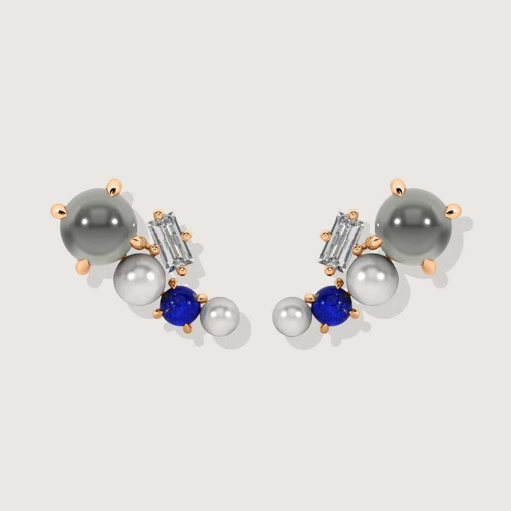 Rose gold cluster stud earrings with pearls, grey, and blue gemstones, laid flat on neutral background.