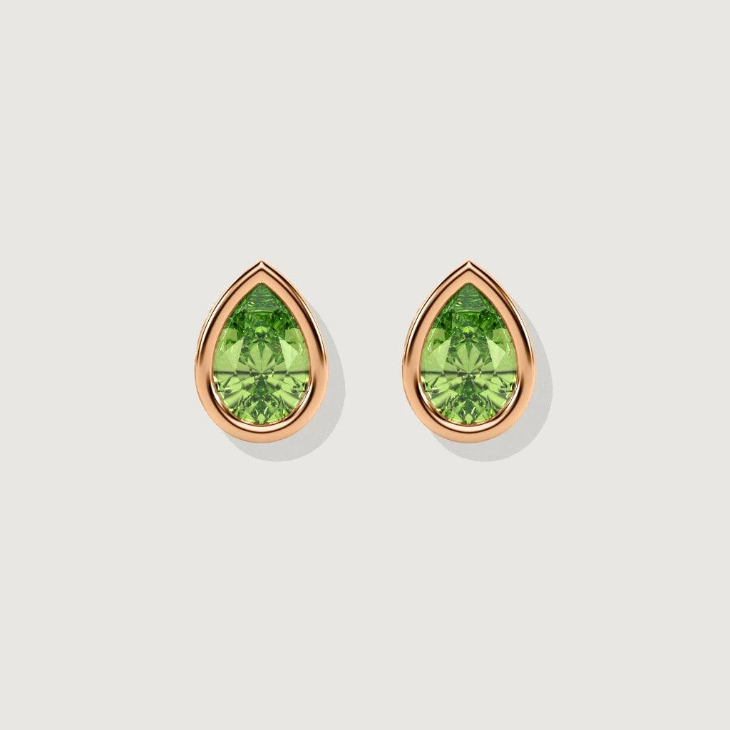 Product shot of a pair of teardrop-shaped green gemstone stud earrings in rose gold bezel settings, displayed on a light background.