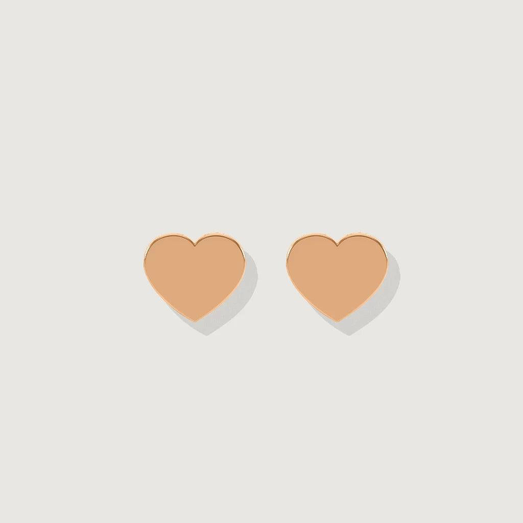 Pair of simple rose gold heart-shaped stud earrings displayed on a light background.