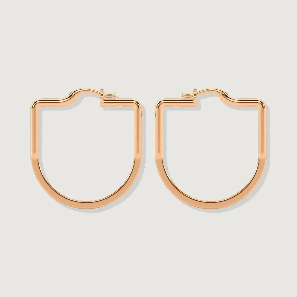 Pair of rose gold geometric hoop earrings displayed on a plain light background, with a flat shield-like shape and smooth polished finish.