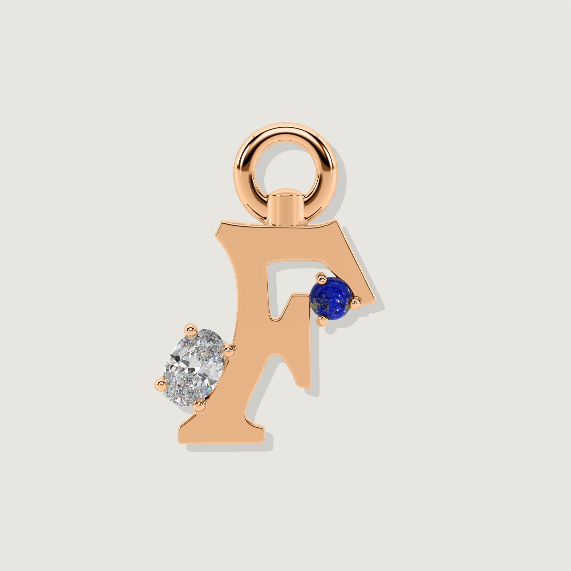 Rose gold letter F charm adorned with a round blue lapis and oval clear stone.