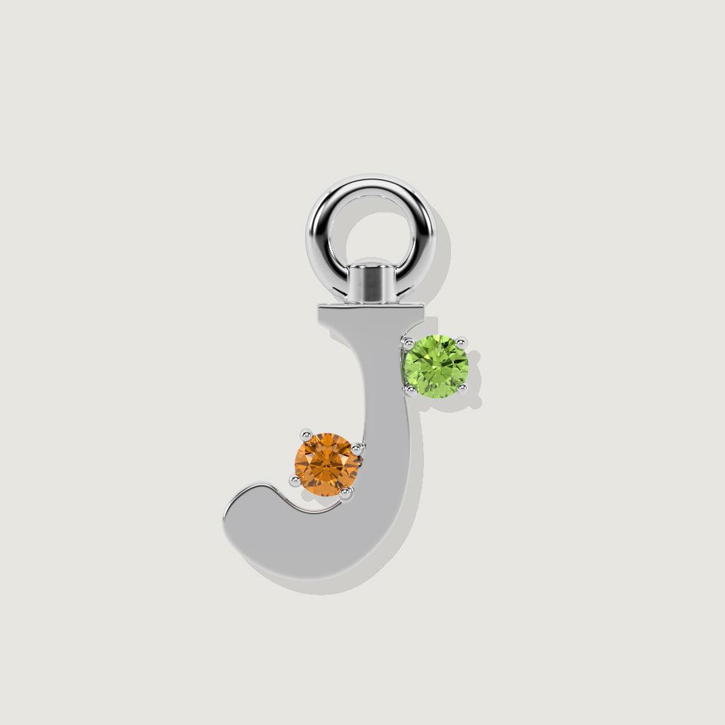 Silver letter J charm with round orange and green gemstones.