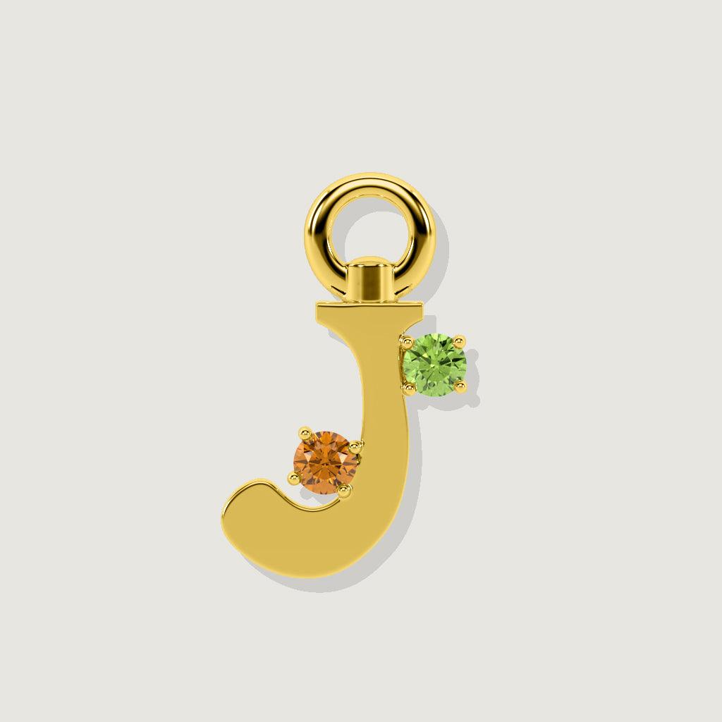 Gold letter J charm with round orange and green gemstones.