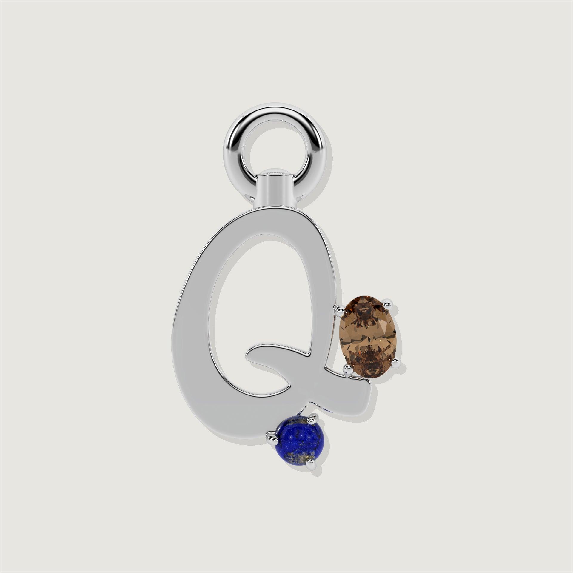 Silver letter Q charm decorated with an oval smoky quartz and a small round lapis-blue gem.