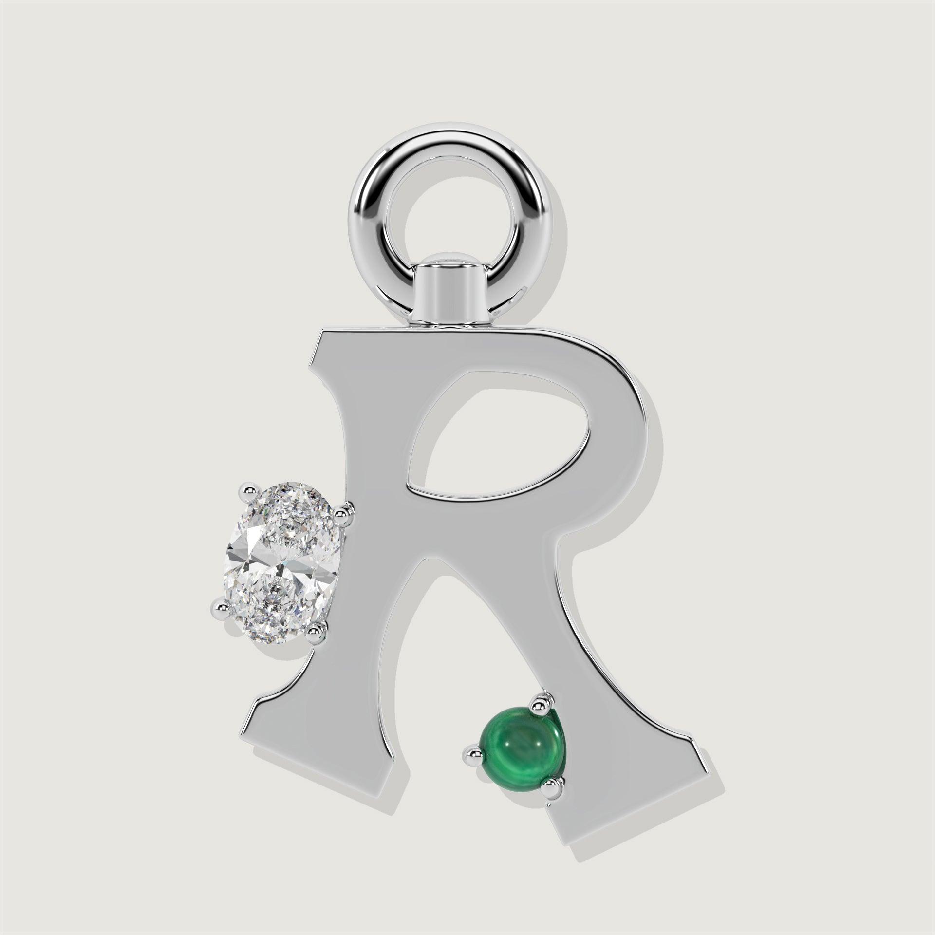 Silver letter R charm embellished with an oval clear stone and a green malachite sphere.
