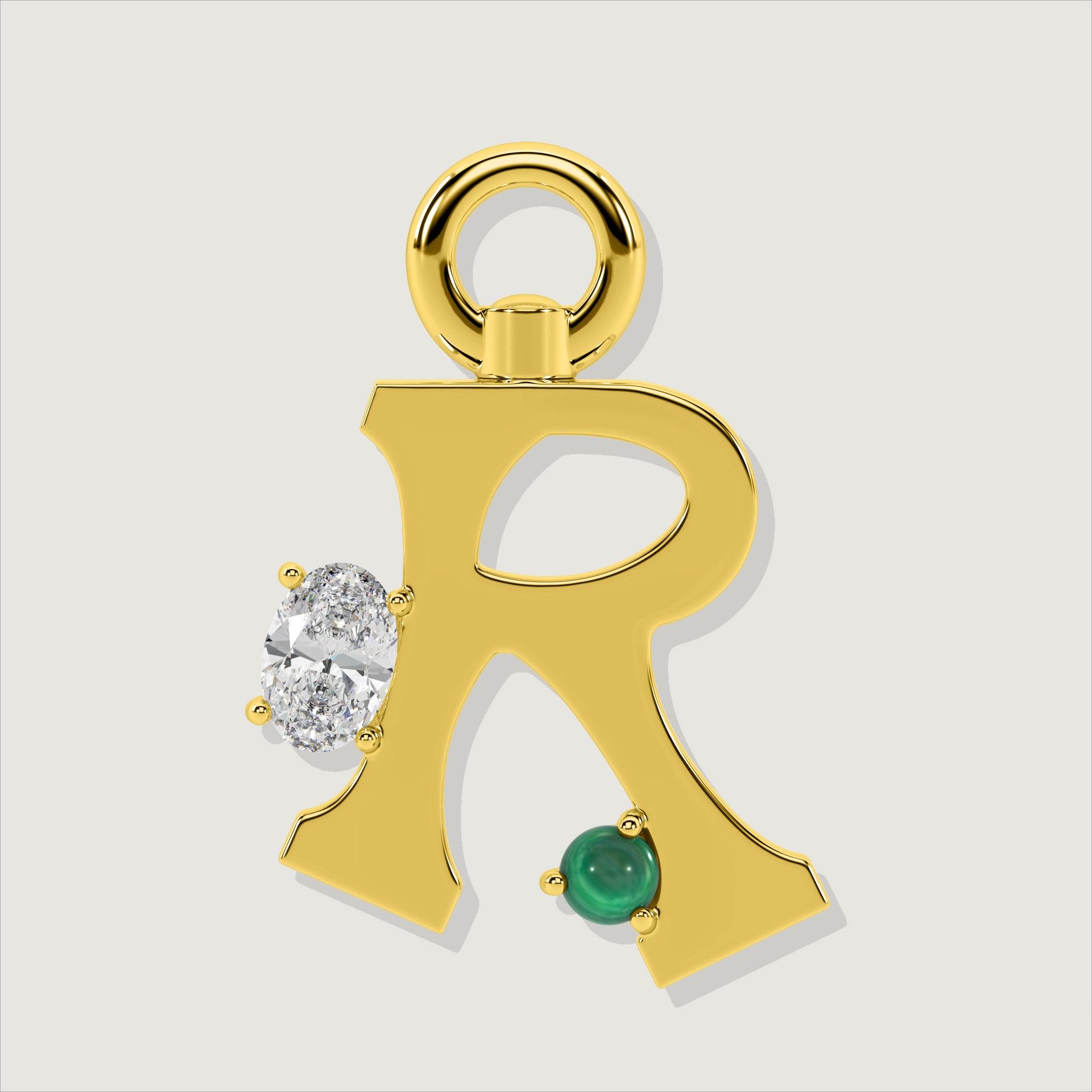 Gold letter R charm embellished with an oval clear stone and a green malachite sphere.