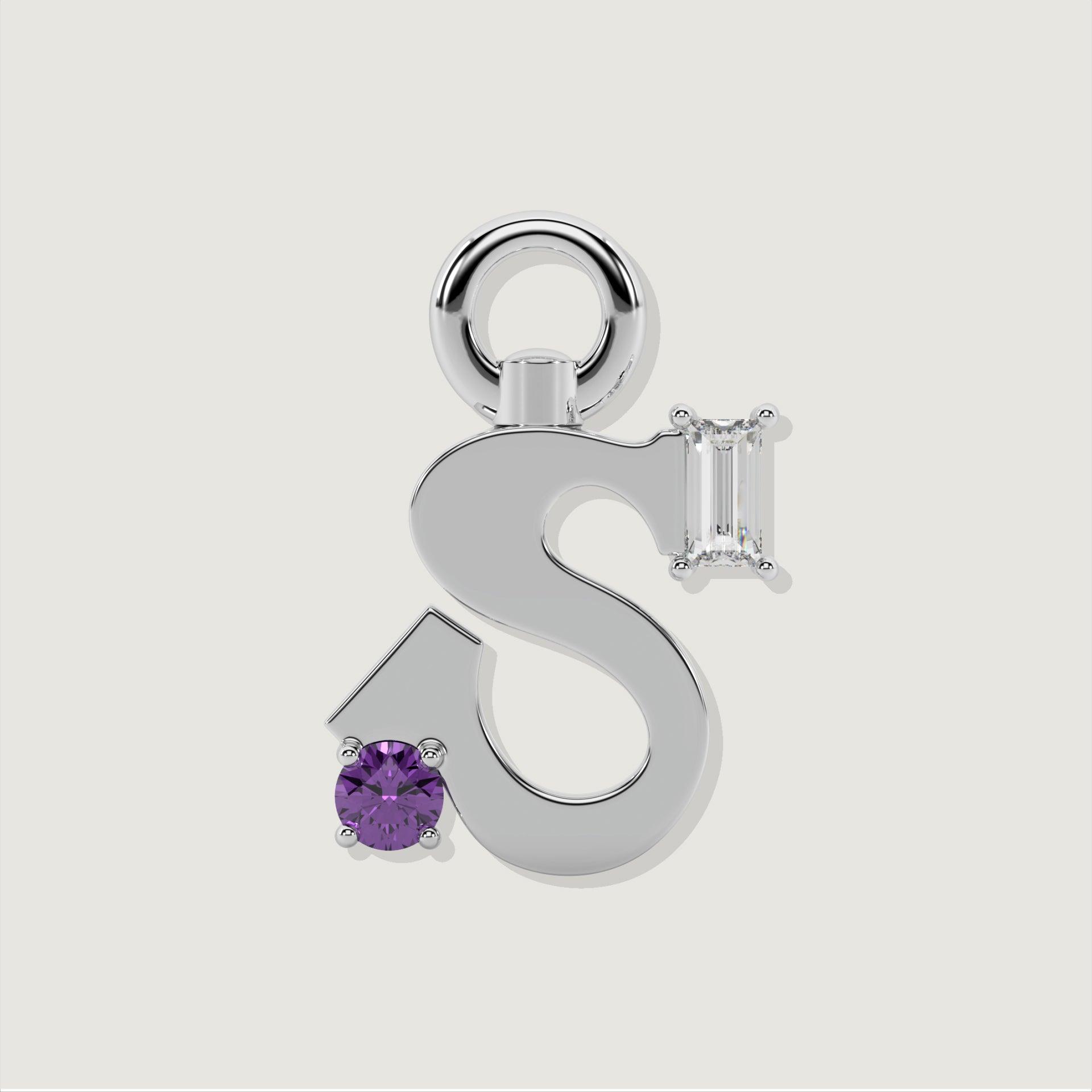 Silver letter S charm featuring a round purple gemstone and a baguette-cut clear stone.