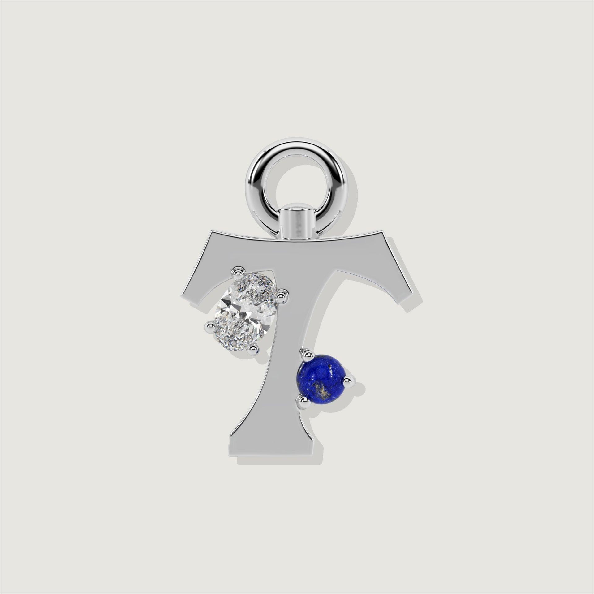 Silver letter T charm with an oval clear stone and a round lapis-blue gem.