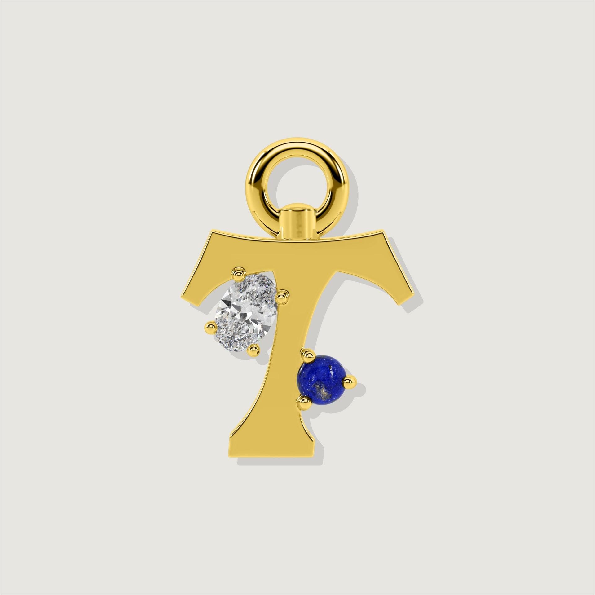 Gold letter T charm with an oval clear stone and a round lapis-blue gem.