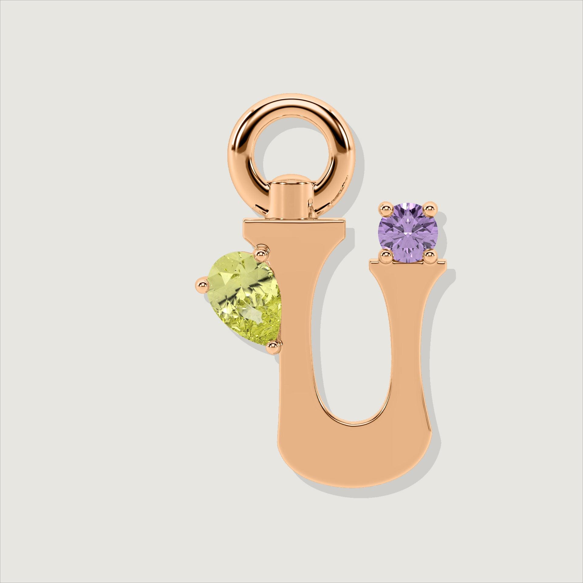 Rose gold letter U charm adorned with a pear-cut yellow gemstone and a round purple gem.