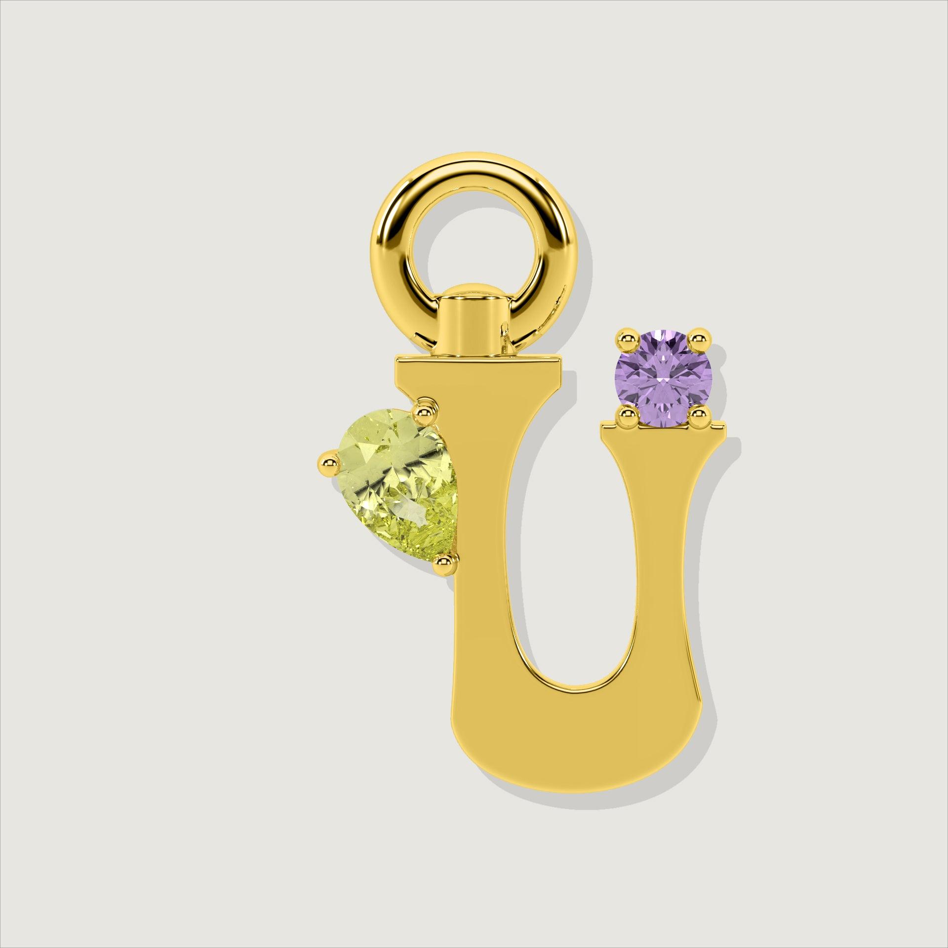 Gold letter U charm adorned with a pear-cut yellow gemstone and a round purple gem.