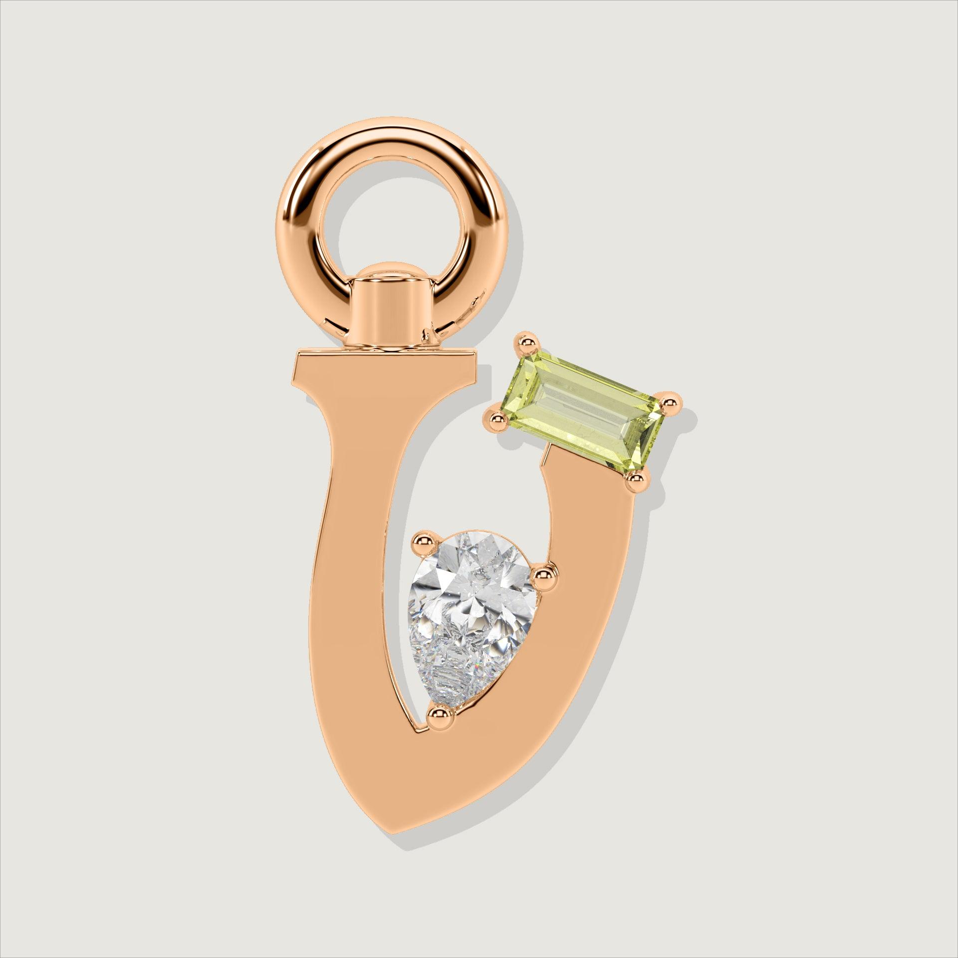 Rose gold letter V charm featuring a baguette-cut yellow gemstone and a pear-cut clear stone.