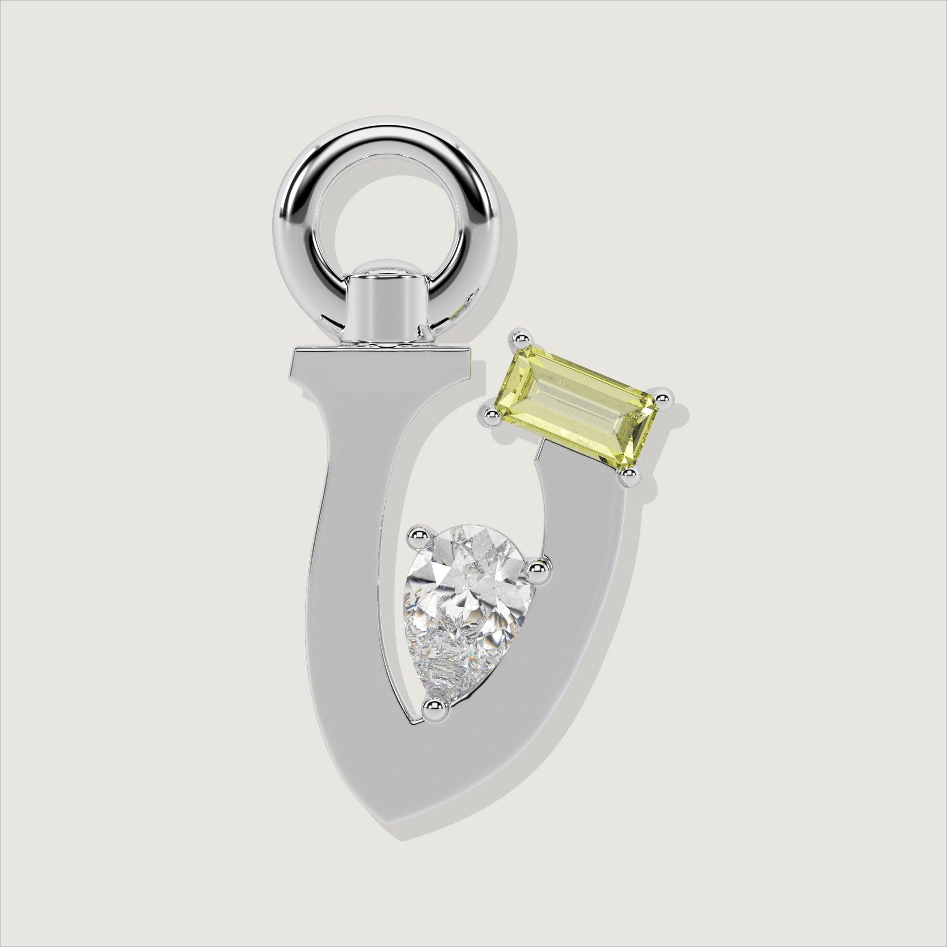 Silver letter V charm featuring a baguette-cut yellow gemstone and a pear-cut clear stone.