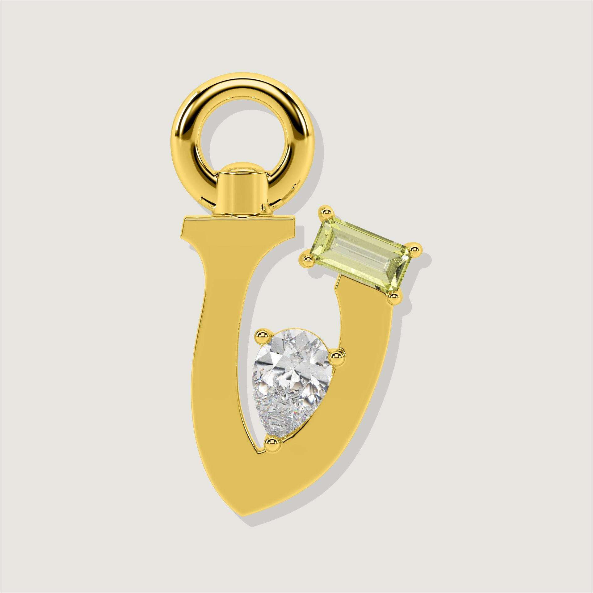 Gold letter V charm featuring a baguette-cut yellow gemstone and a pear-cut clear stone.