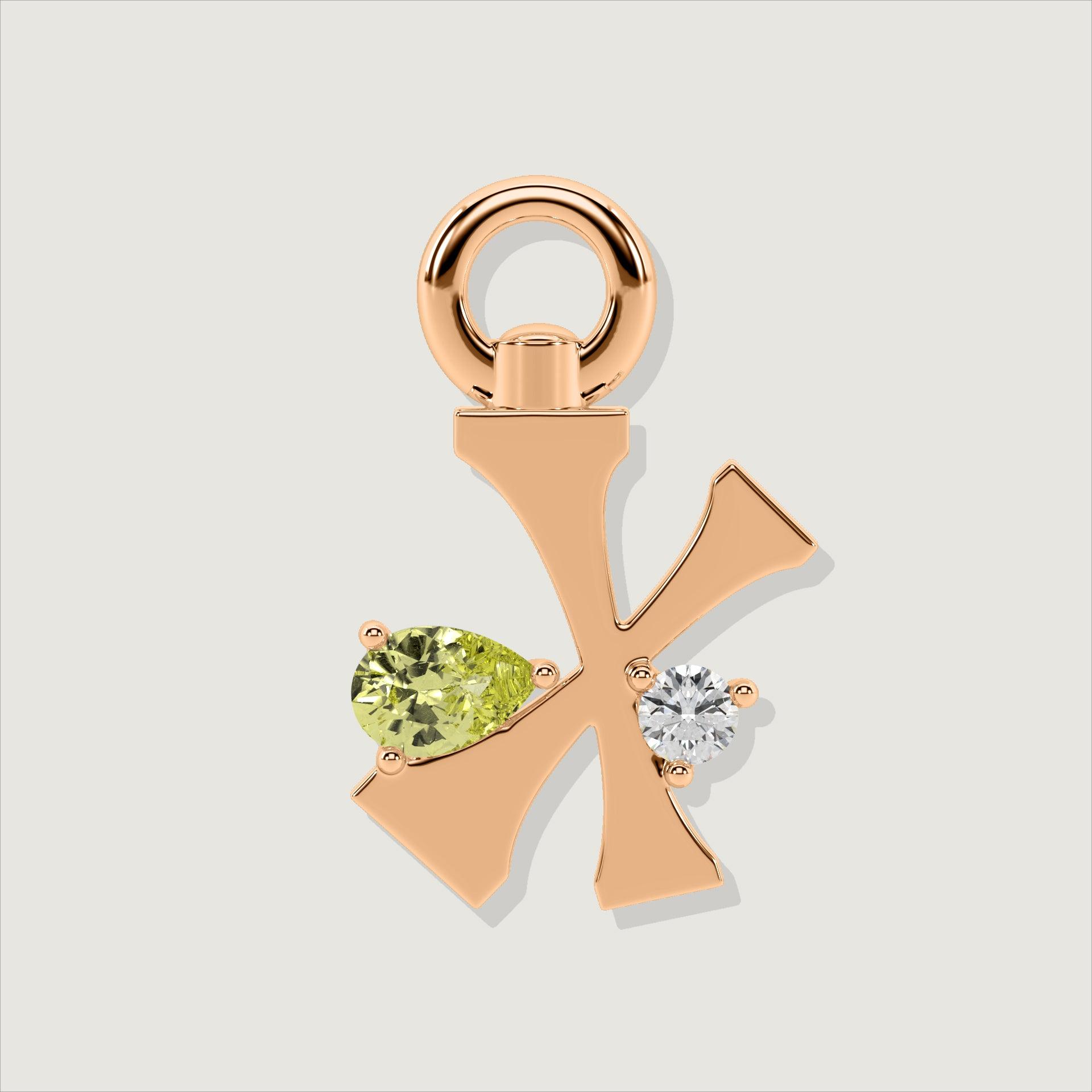 Rose gold letter X charm decorated with a pear-cut yellow gemstone and a clear round stone.