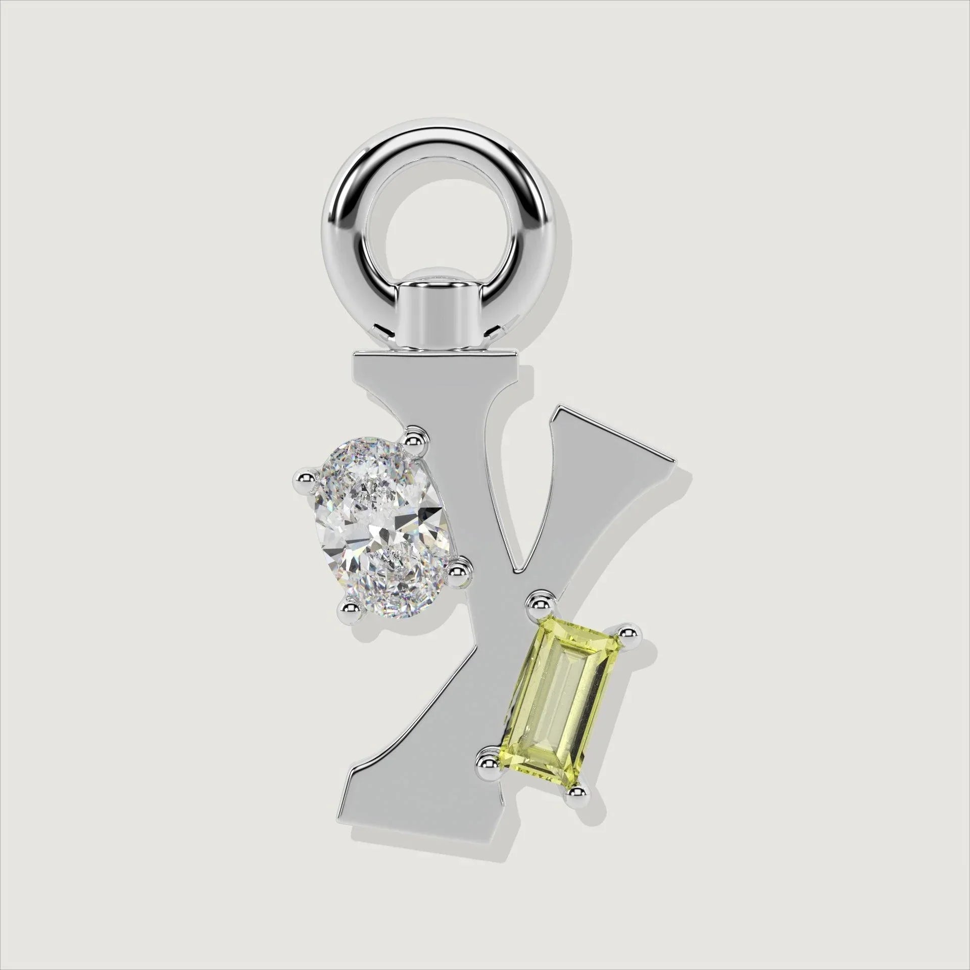 Silver letter Y charm accented with an oval clear stone and a baguette-cut yellow gemstone.
