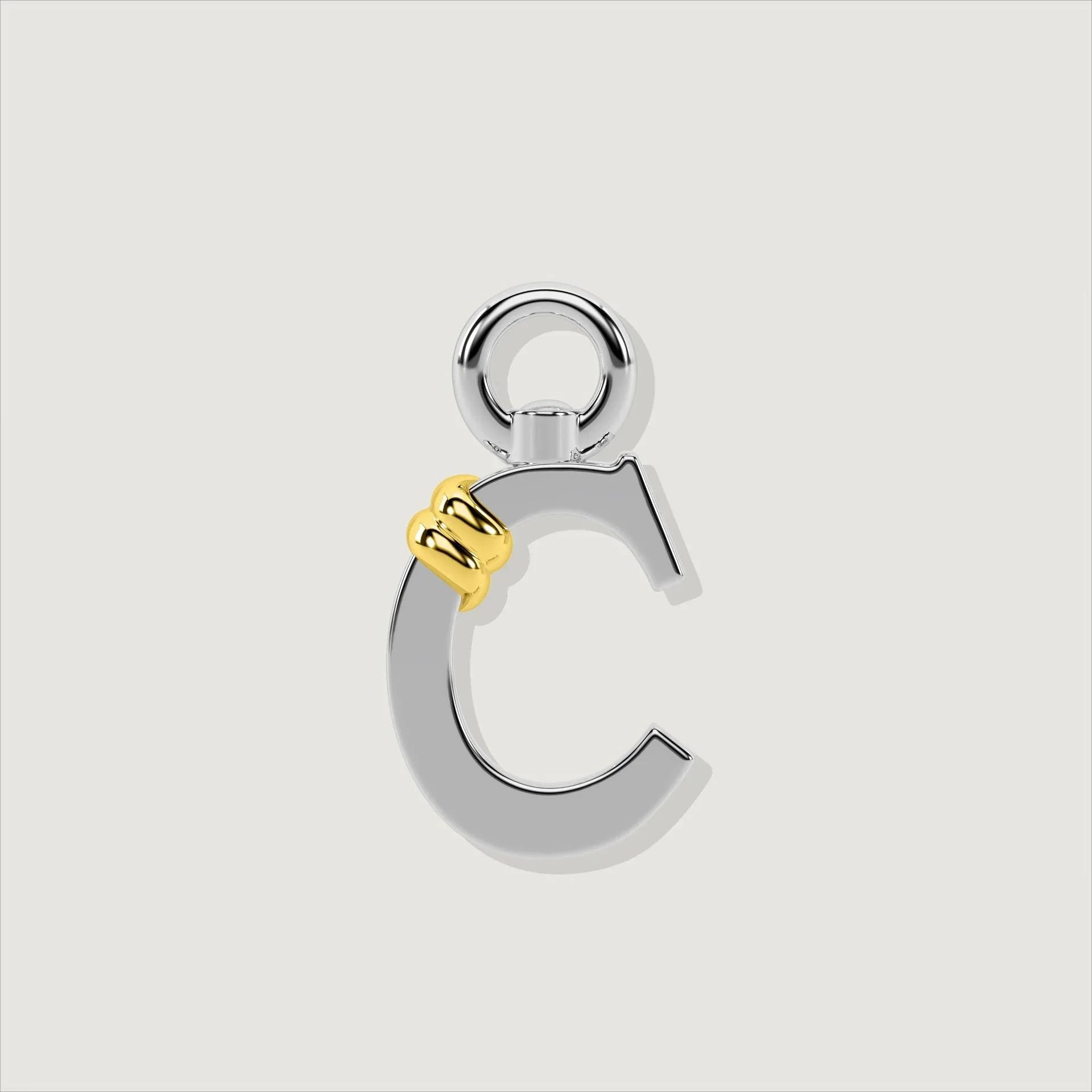 Silver letter C charm with gold rope twist detail.