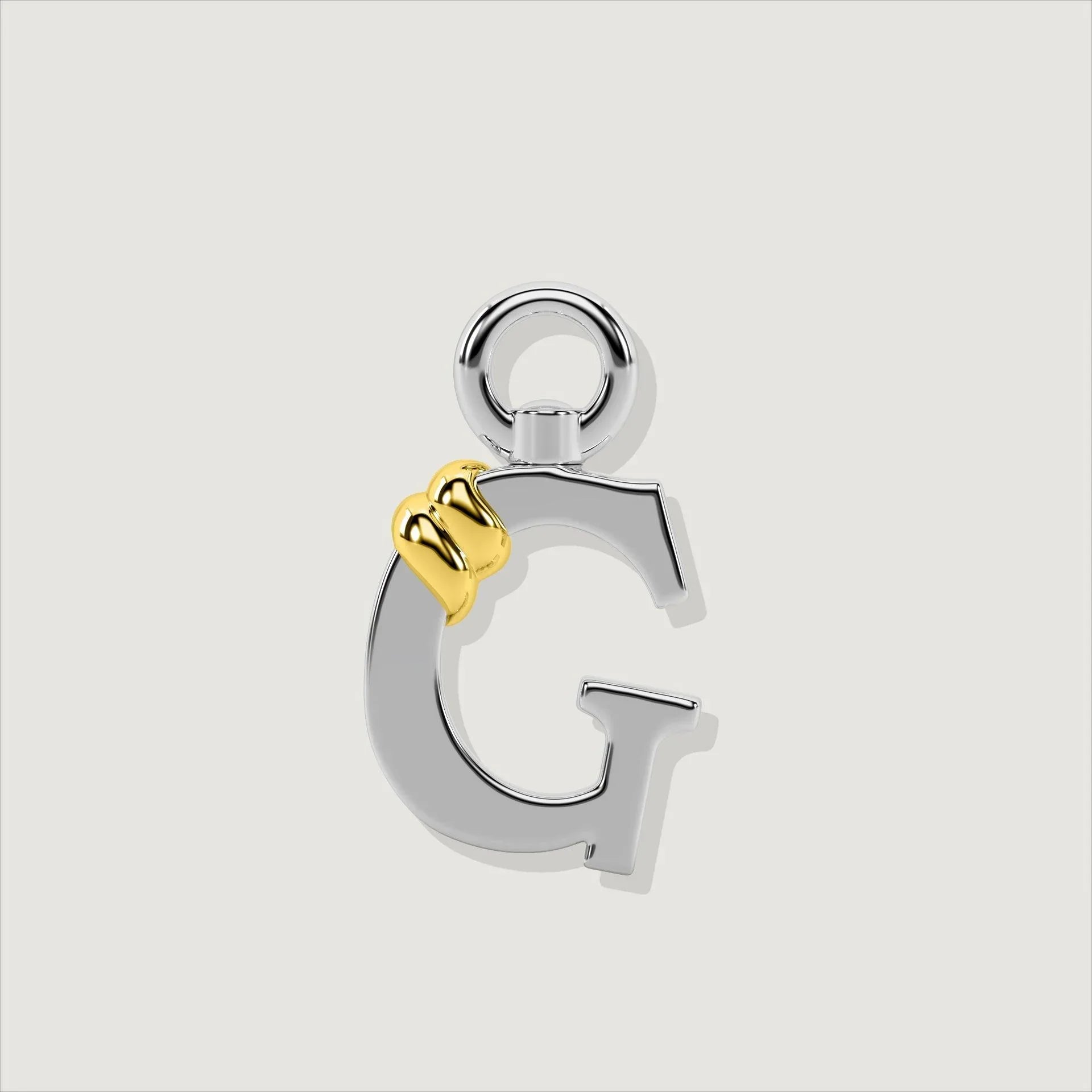 Silver letter G charm with gold rope twist detail.