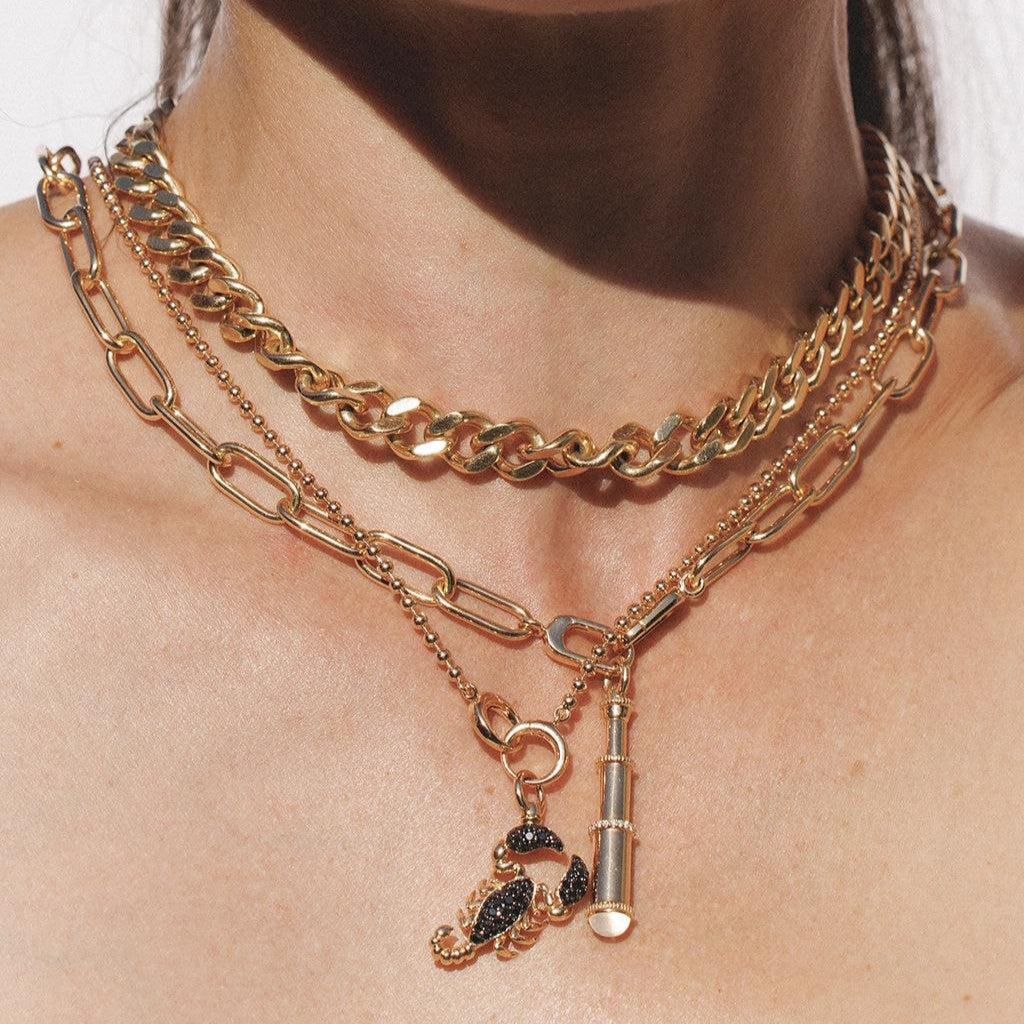 Layered gold necklaces with scorpion and telescope charms